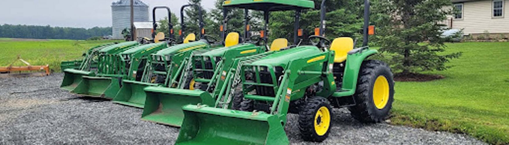 Line of small green tractors